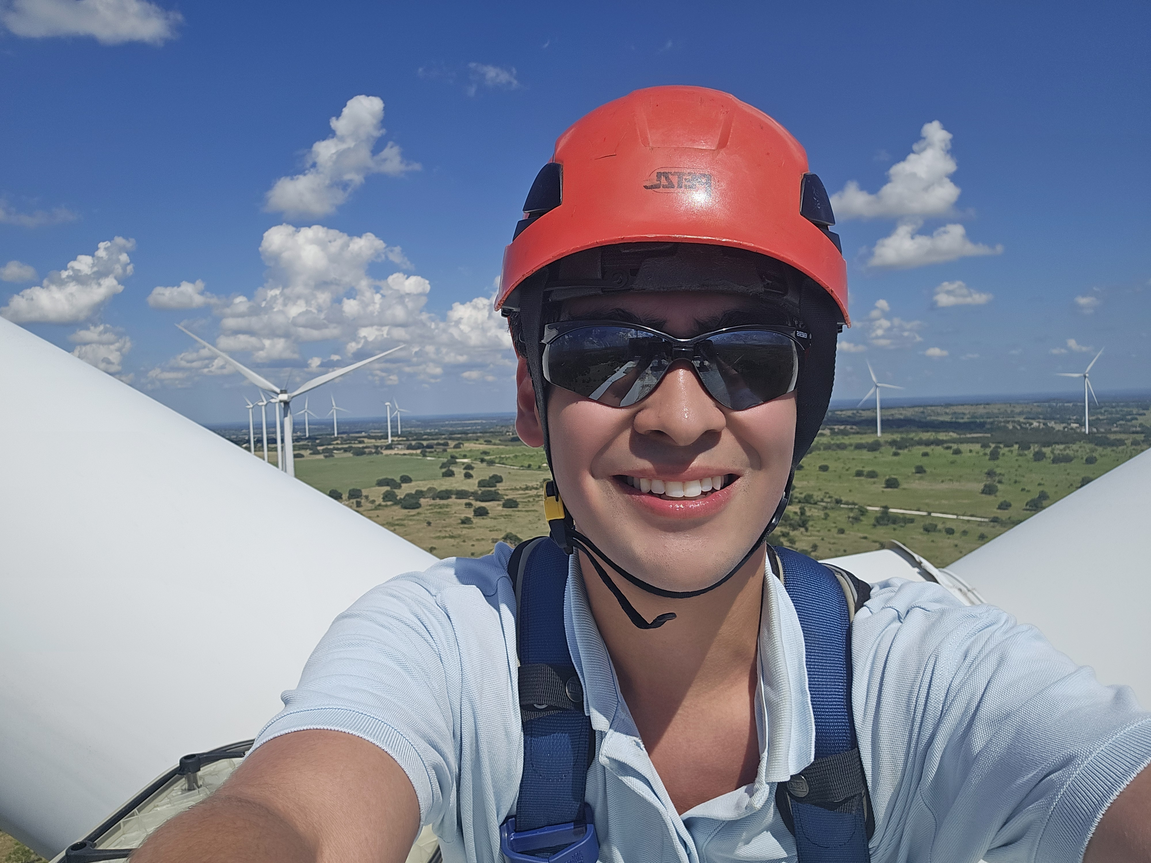 Summer Intern Smiling on Top of a Wind Turbine
