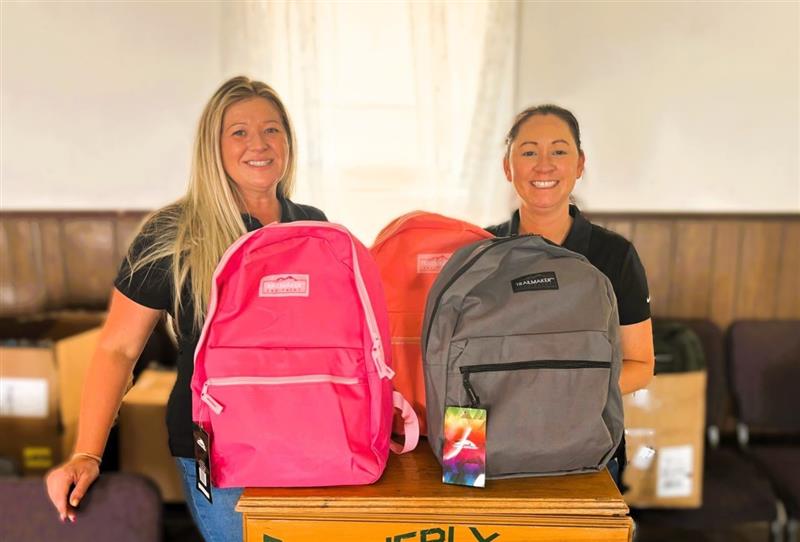Employees Helping with a Backpack Drive